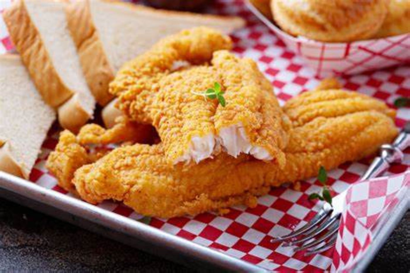 Golden fried fish fillets with lemon slices